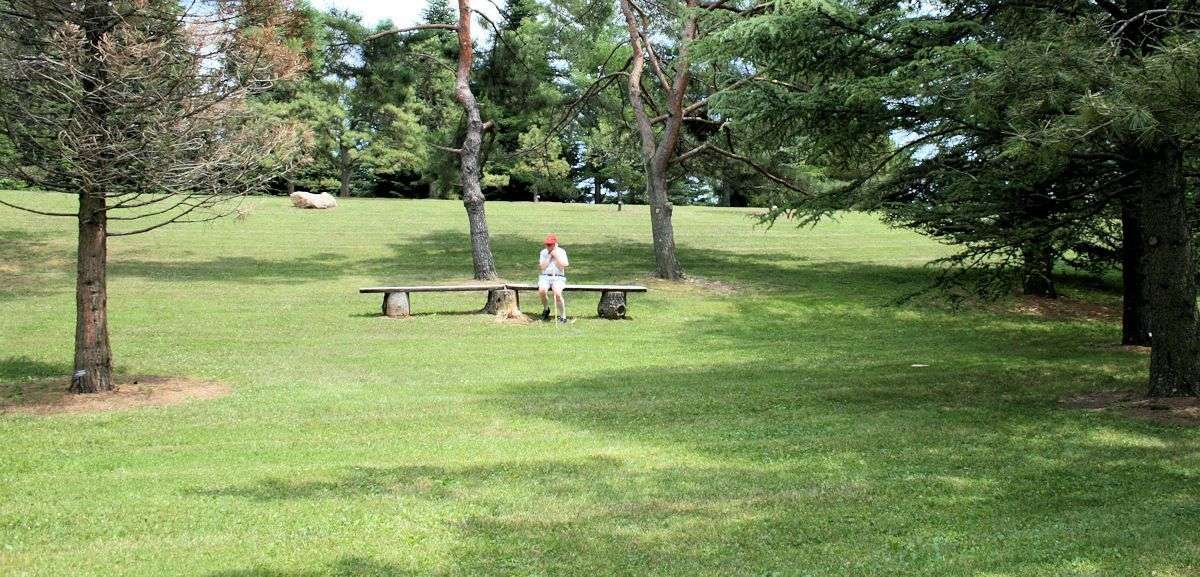 man sitting on bench in park waiting for God's compassion like a Prodigal Son